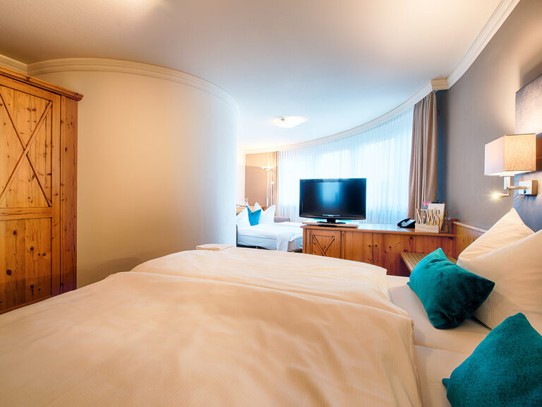 Das harmonisch beleuchtete Hotelzimmer der Nähe Stuttgarts, ausgestattet mit einem behaglichen Bett und TV.