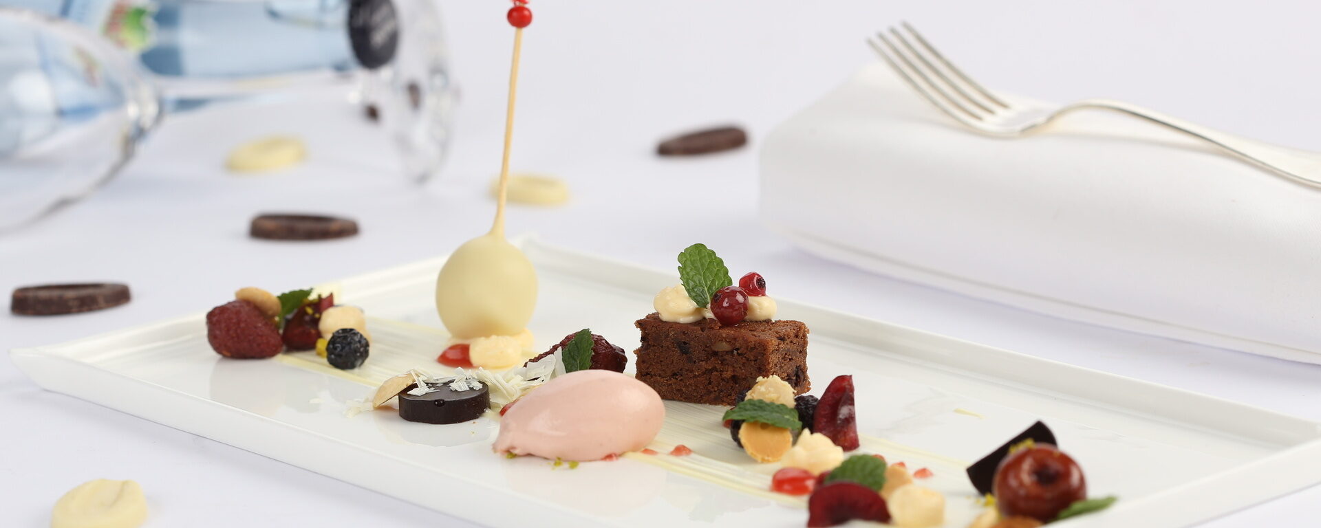 Ein weißer Teller mit raffinierten Desserts im Sterne-Restaurant Landhaus Feckl bei Stuttgart.