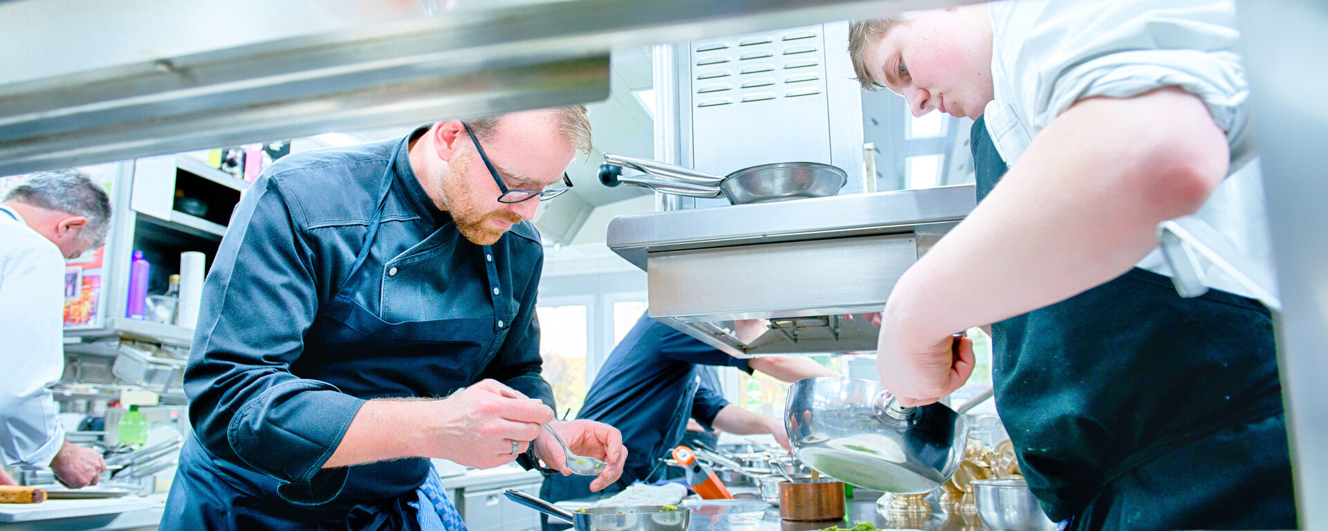 Das Team von Köchen in der Küche des Sternerestaurant Landhaus Feckl bei Stuttgart, konzentriert sich auf die Zubereitung der Speisen.